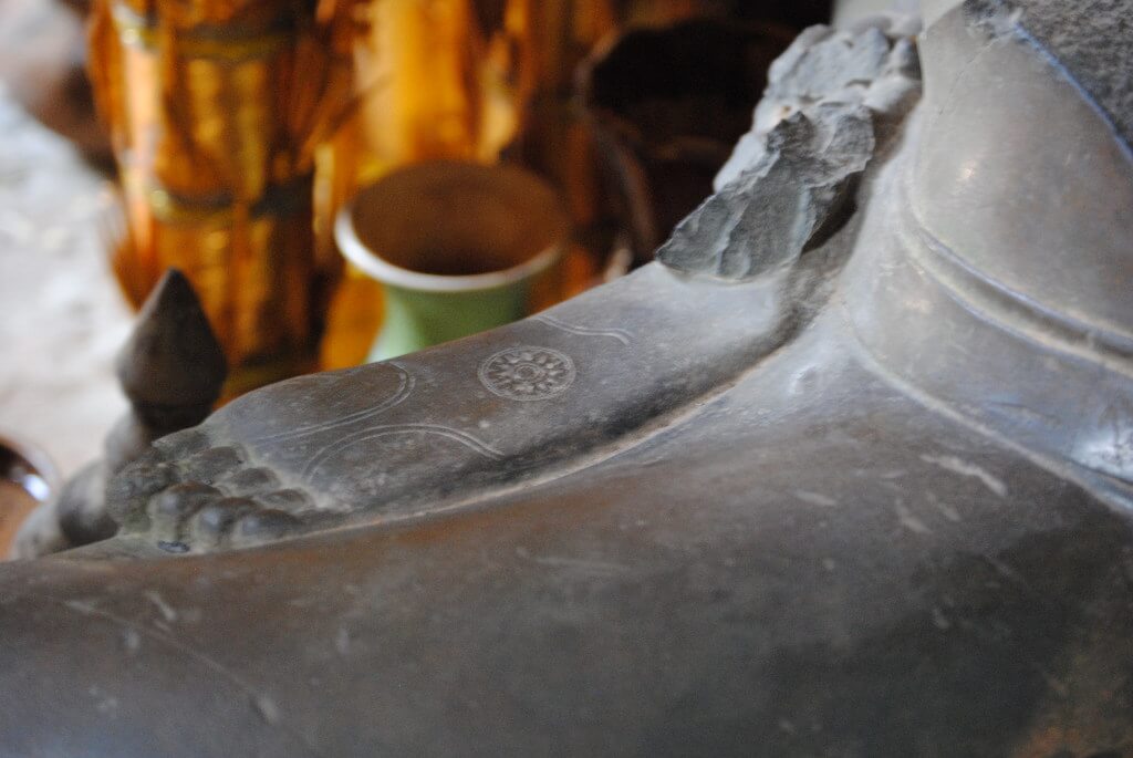 Der Kreis des Lebens unter dem Fuß von Buddha im Banteay Kdei Tempel