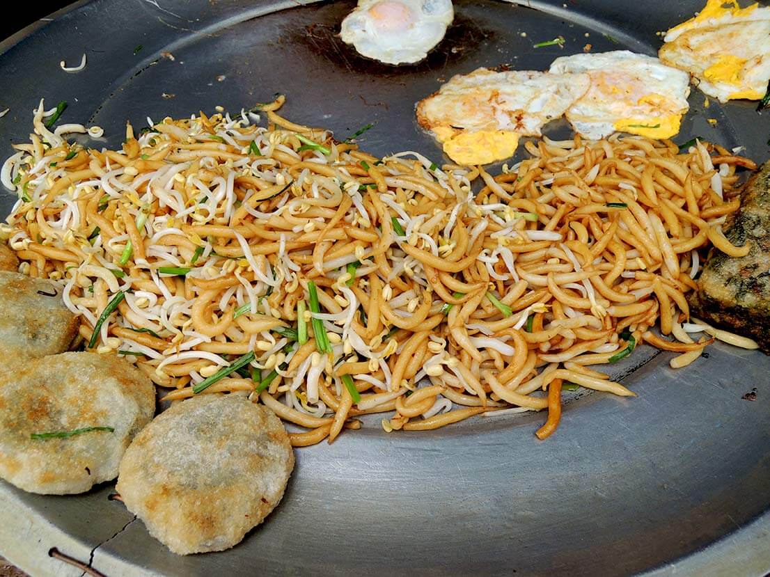 Breakfast on tour: stir-fried rice noodles, duck egg, and rice patty stuffed with chives