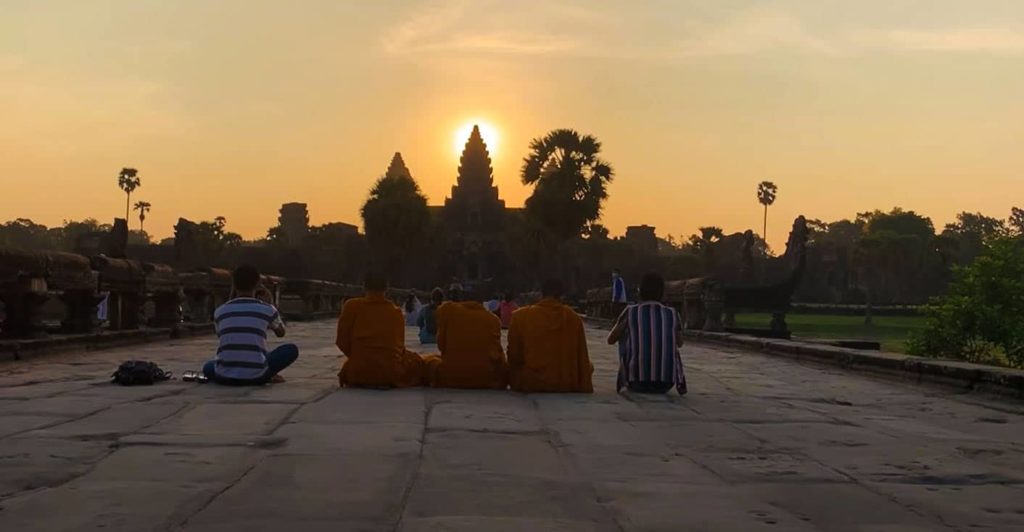 Sunrise at Angkor Wat during equinox and Covid. Just a few visitors sitting in front on the floor. 